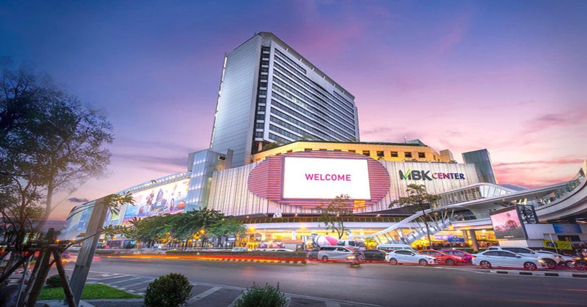 MBK Center illuminated against the Bangkok evening sky