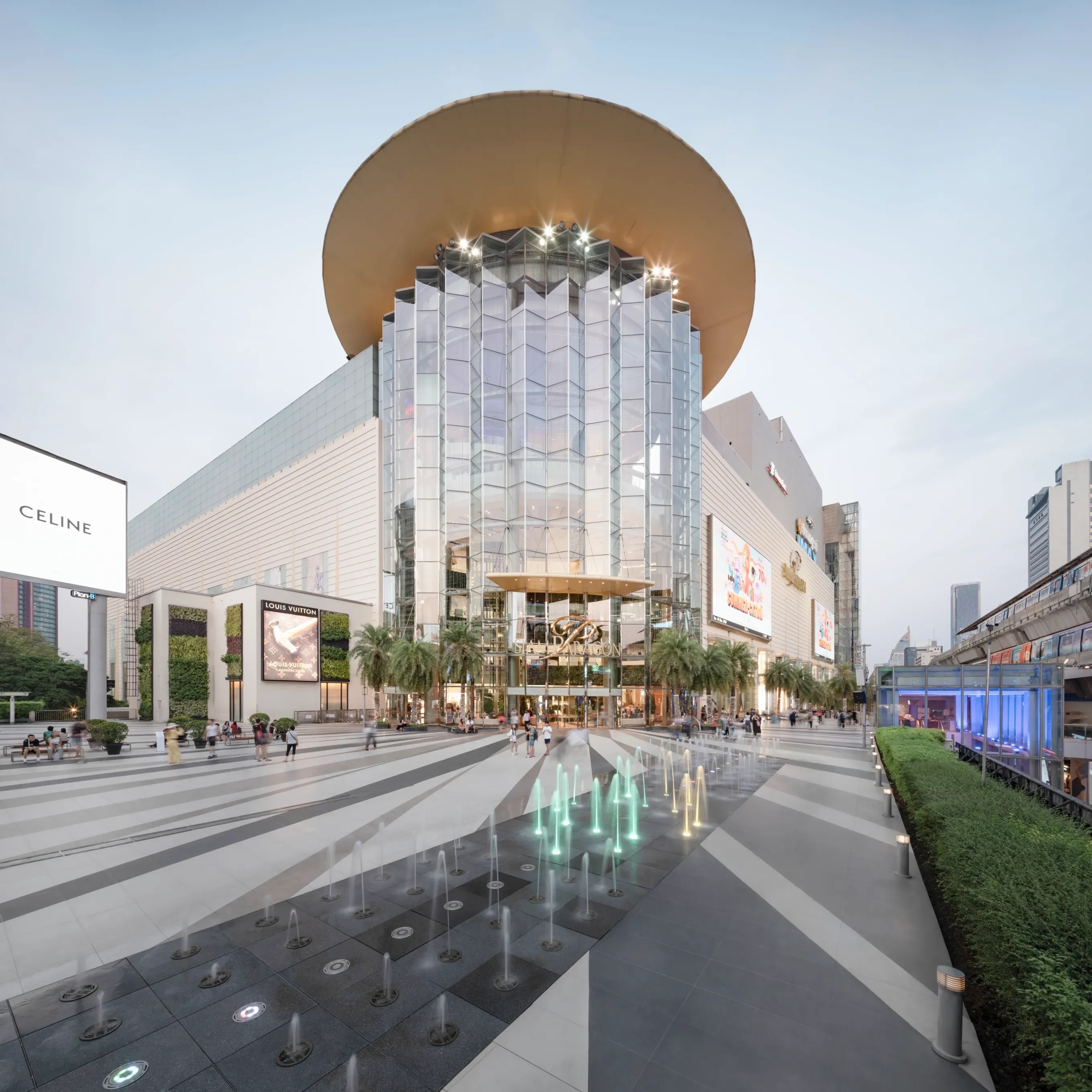 The modern glass entrance and plaza at Siam Paragon